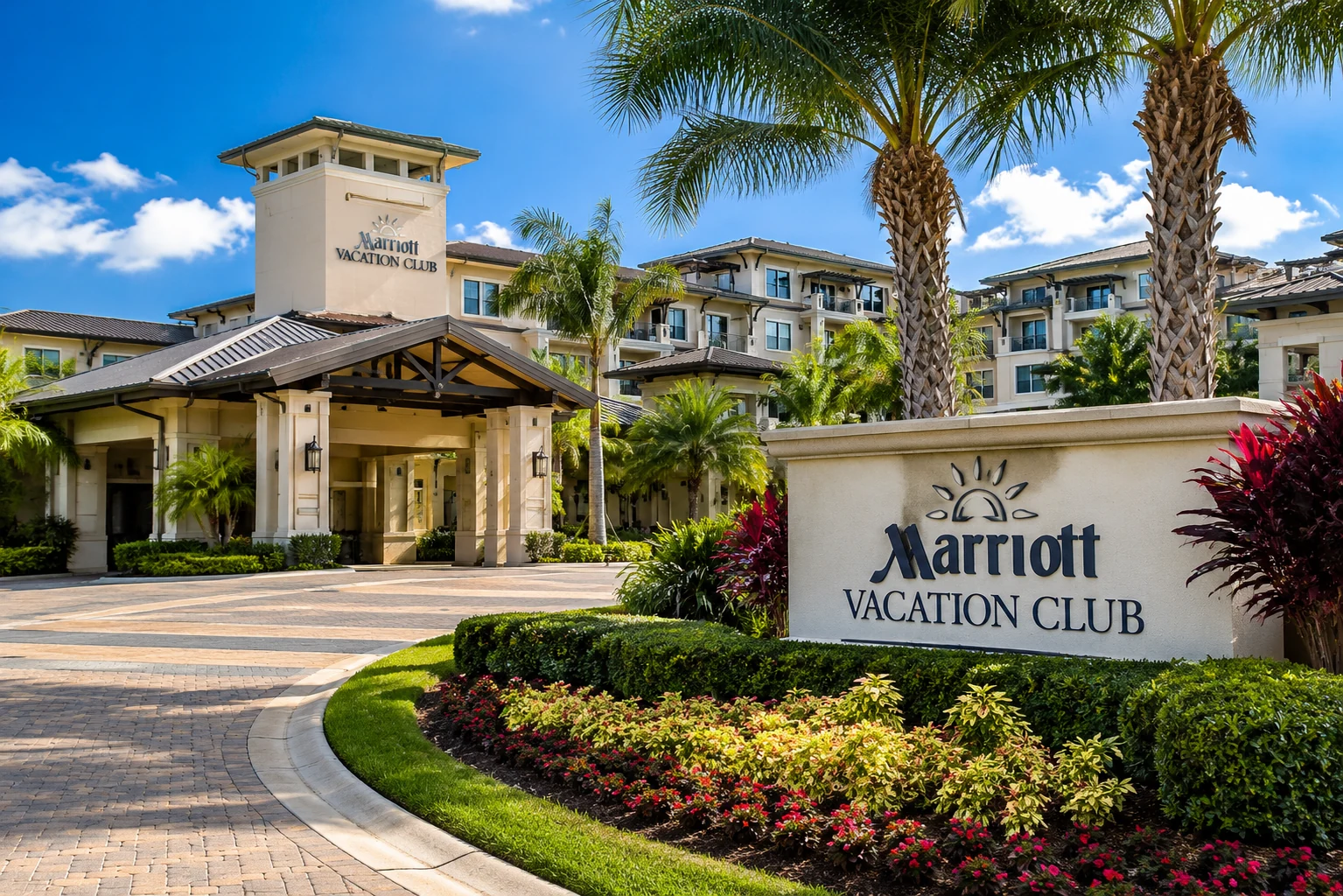Marriott Vacation Club-style resort entrance with palm trees, landscaping, and a resort building representing vacation ownership and resort access.