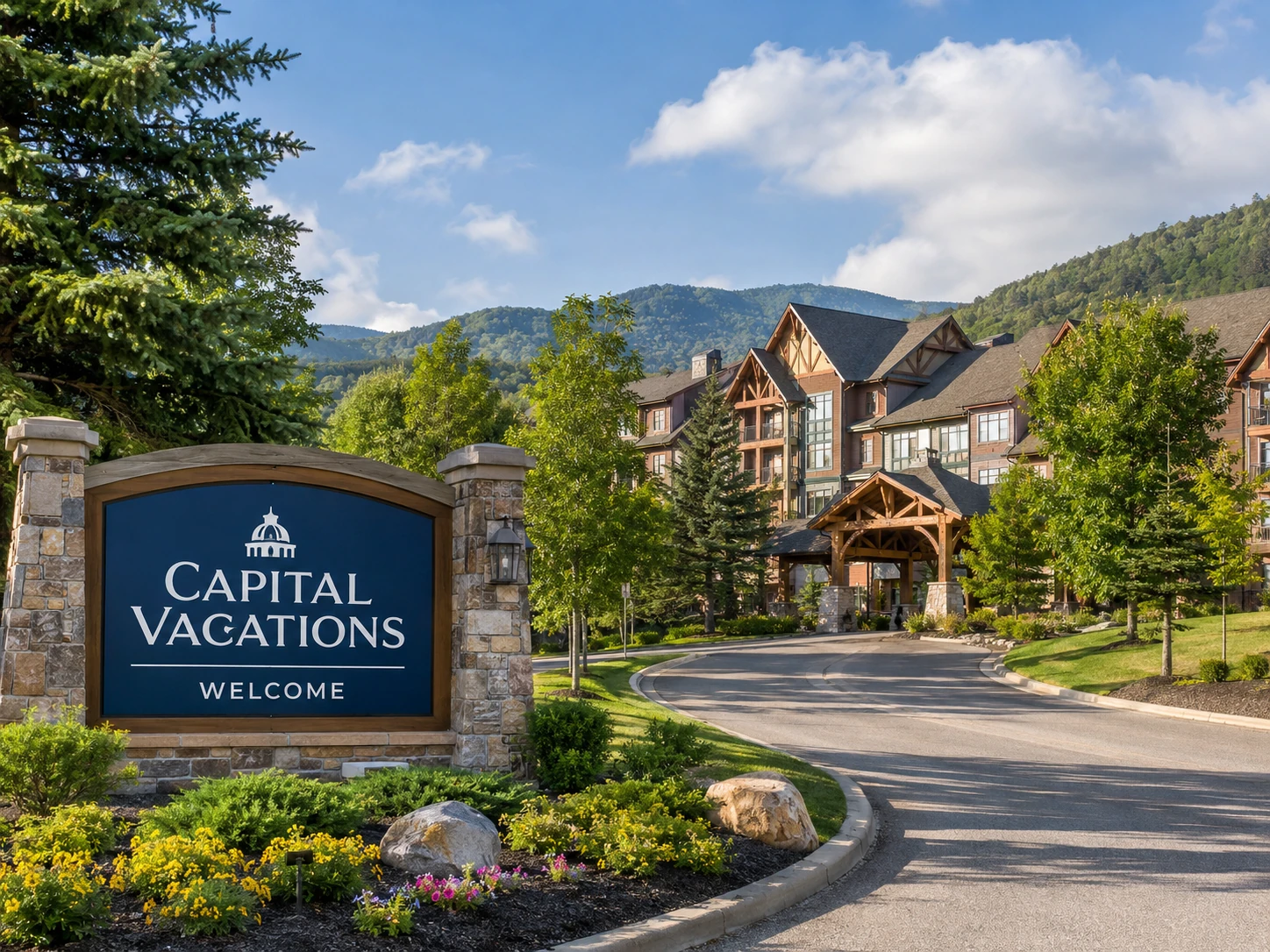 Capital Vacations-style mountain resort entrance with lodge buildings, landscaped grounds, and a vacation ownership welcome sign.